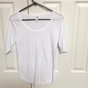 Mid-sleeve, white, scoop neck shirt.